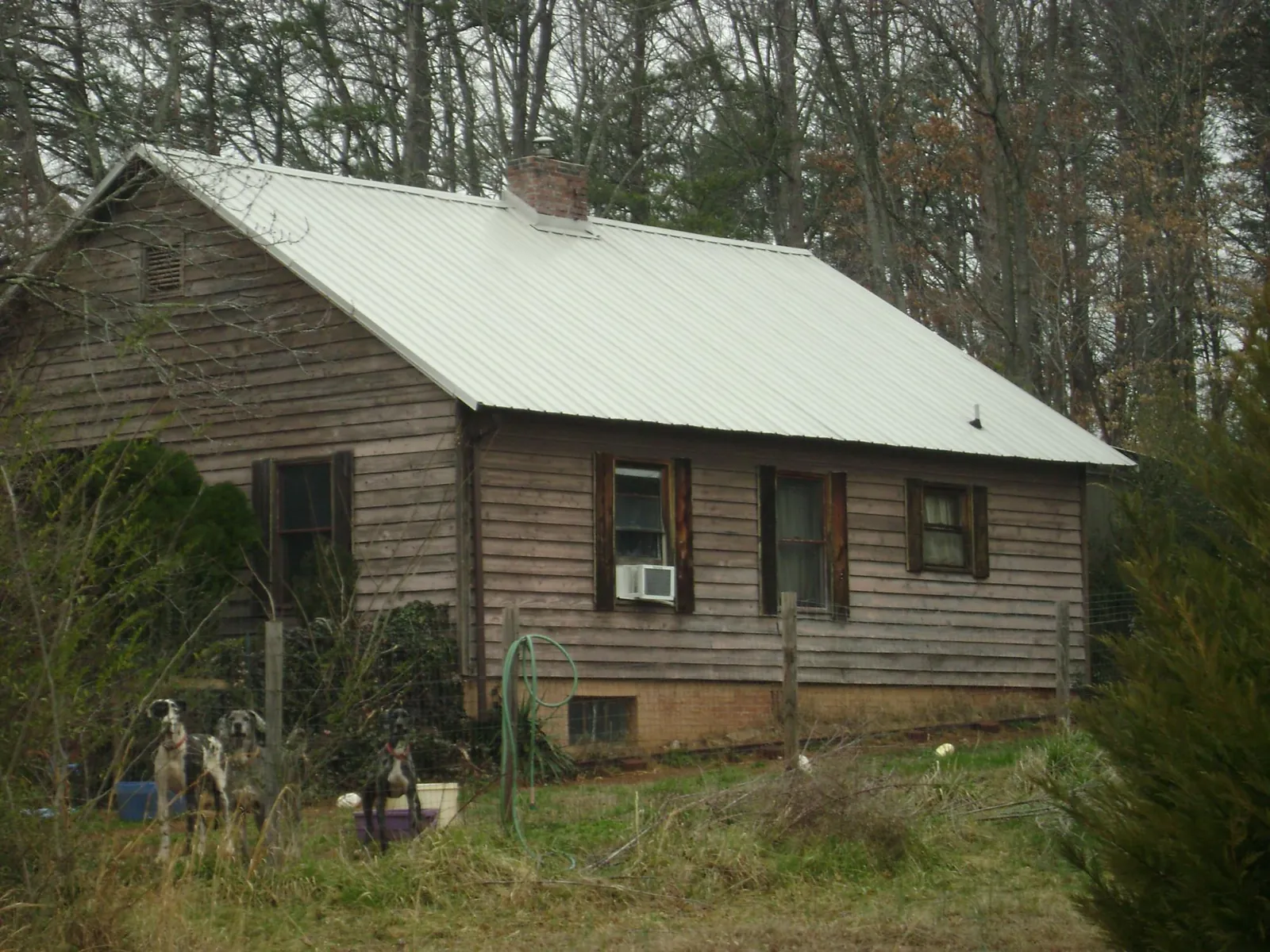 White metal roof on an old wood sided farmhouse, from a Metal Roof Installation job in Narragansett